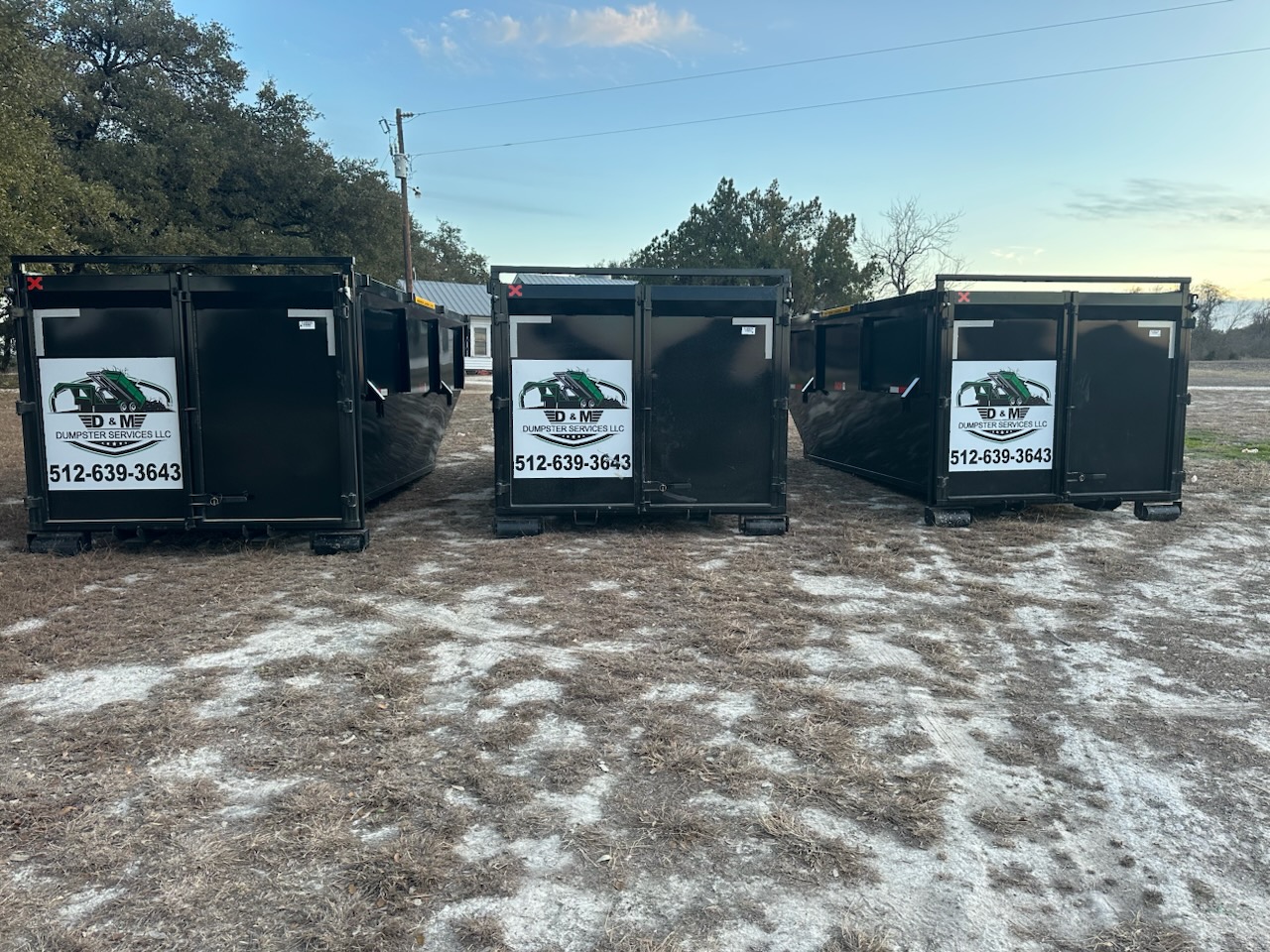 Three D&M Dumpster Services roll off dumpsters on a frosty Central Texas morning