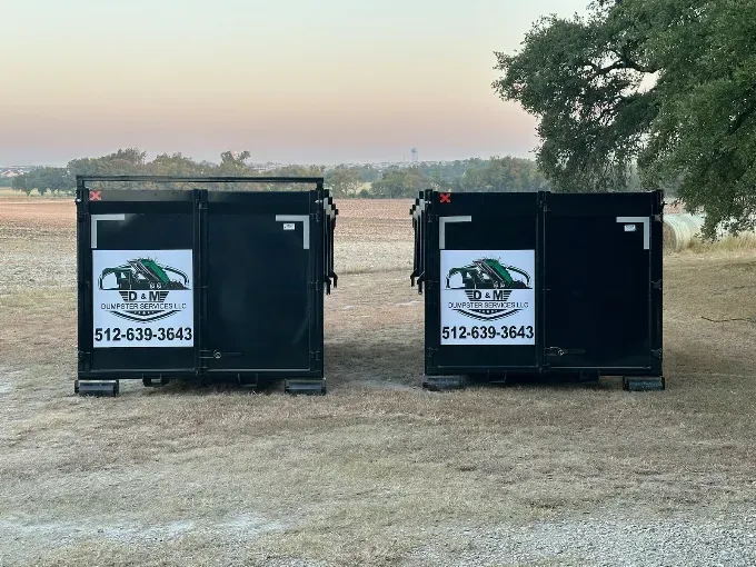 Two D&M roll off dumpsters set on a Central Texas property at sunset
